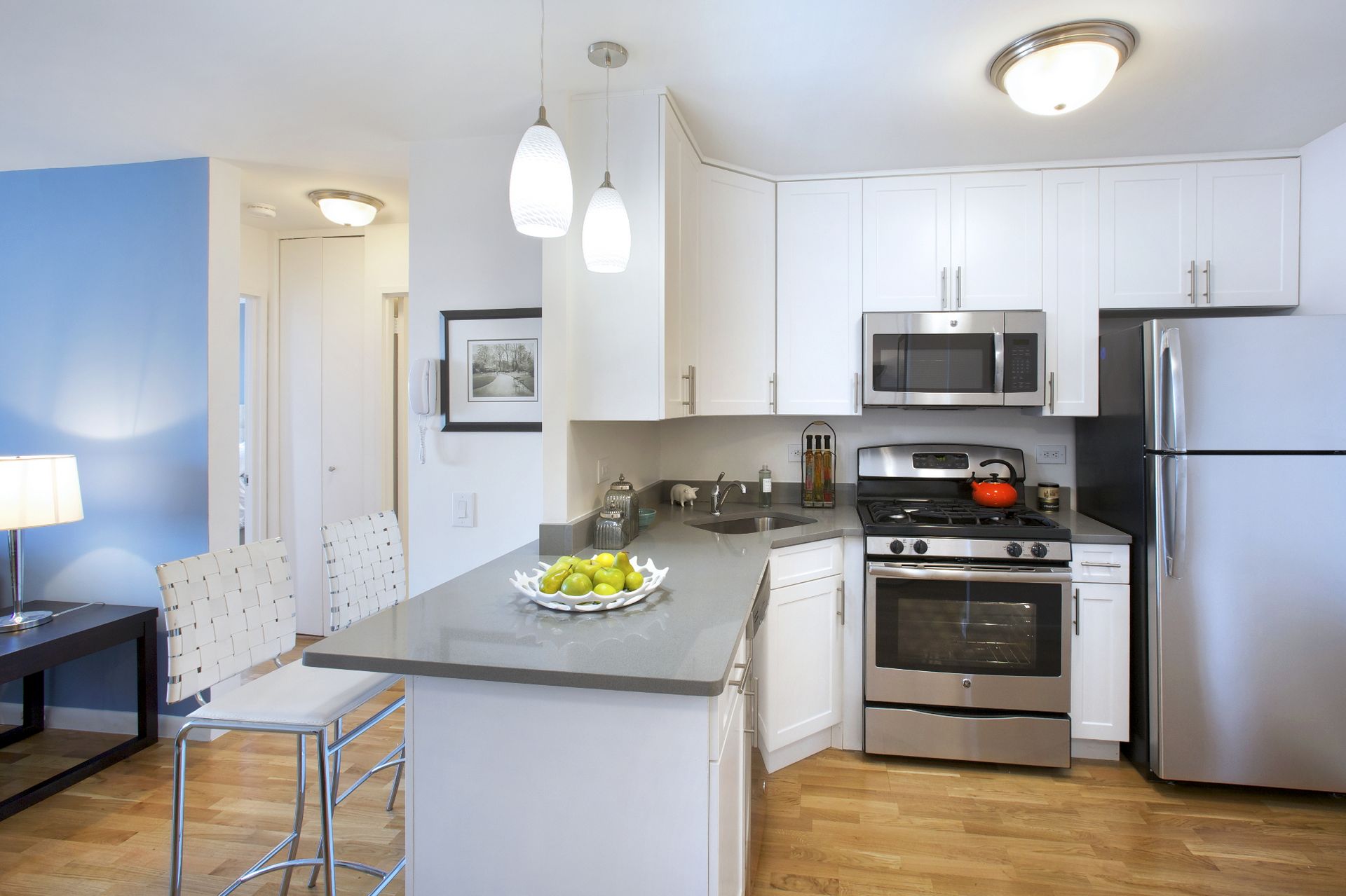 a kitchen with stainless steel appliances granite countertop a sink stove and refrigerator