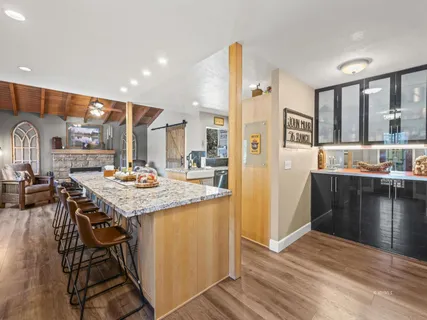 a kitchen with stainless steel appliances kitchen island granite countertop a sink and cabinets