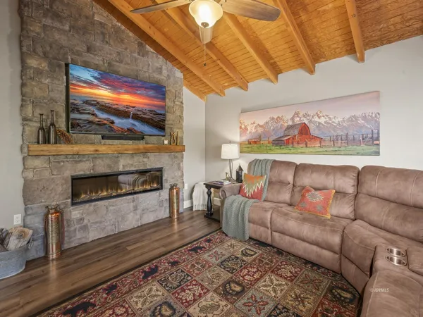 a living room with furniture a fireplace and a flat screen tv