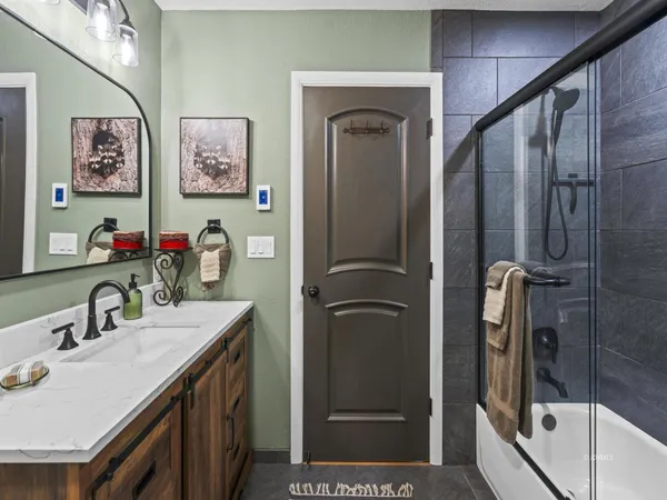 a bathroom with a sink vanity and a mirror