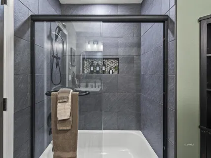 a bathroom with a glass shower door