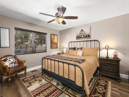 a bedroom with a bed dresser and a window