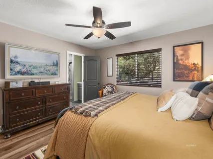 a bed sitting in a bedroom next to a window