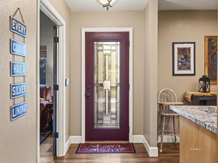 a view of a hallway with workspace and mirror