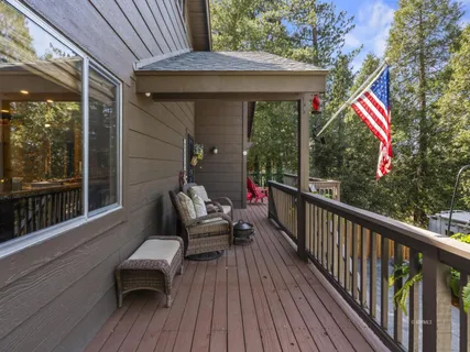 a balcony with wooden floor and outdoor space