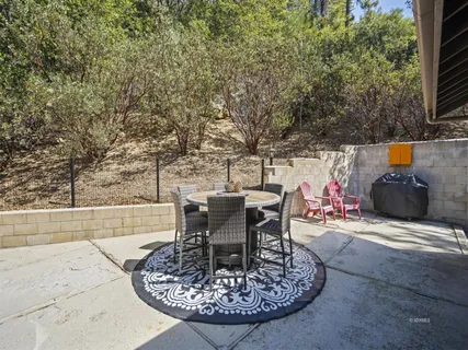 a view of a backyard with sitting area