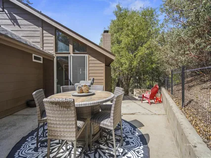 a view of a patio with a table and chairs