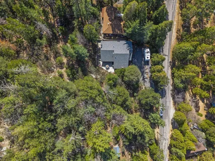 an aerial view of a house with a yard