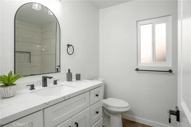 a bathroom with a toilet sink and mirror