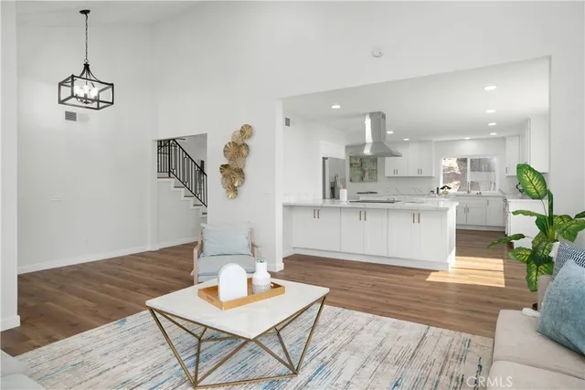 a living room with kitchen island furniture and wooden floor