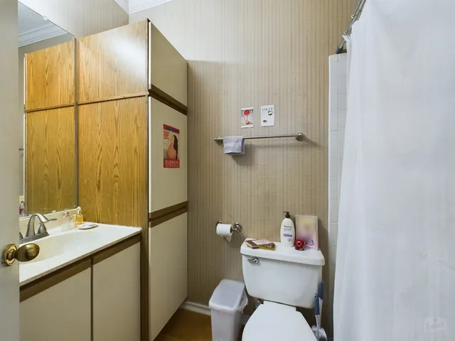 a bathroom with a sink mirror toilet and shower