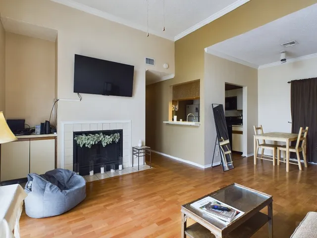 a living room with furniture a fireplace and a flat screen tv