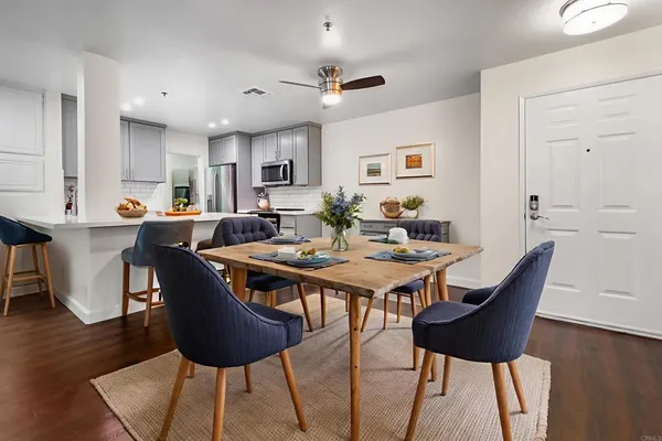 a view of a dining room with furniture and wooden floor