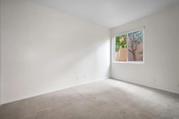 an empty room with windows and wall painting