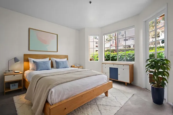 a bedroom with a bed and a window