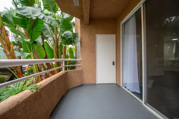 a view of balcony with small yard