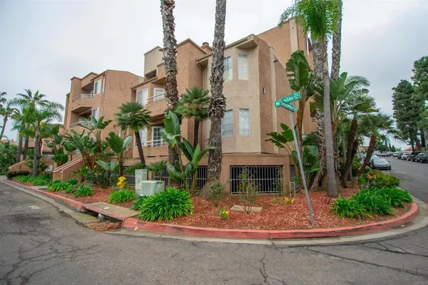 front view of a house with a yard and potted plants