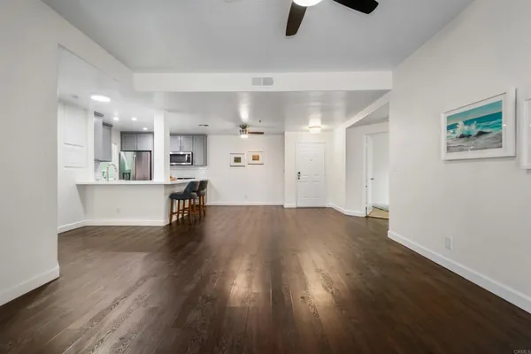a view of a kitchen and wooden floor