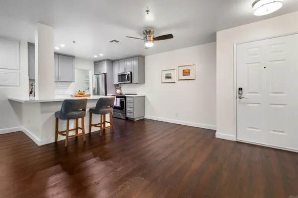 a living room with furniture and a wooden floor
