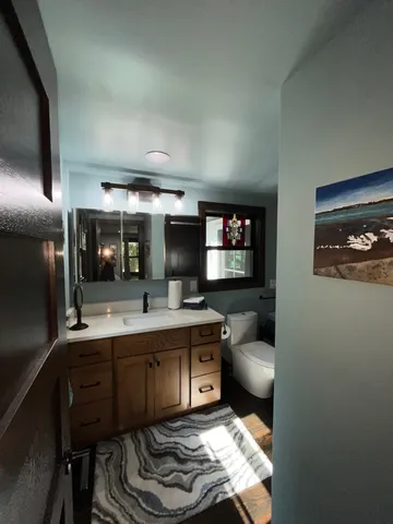 a backyard of a house with lots of green space and outdoor seating