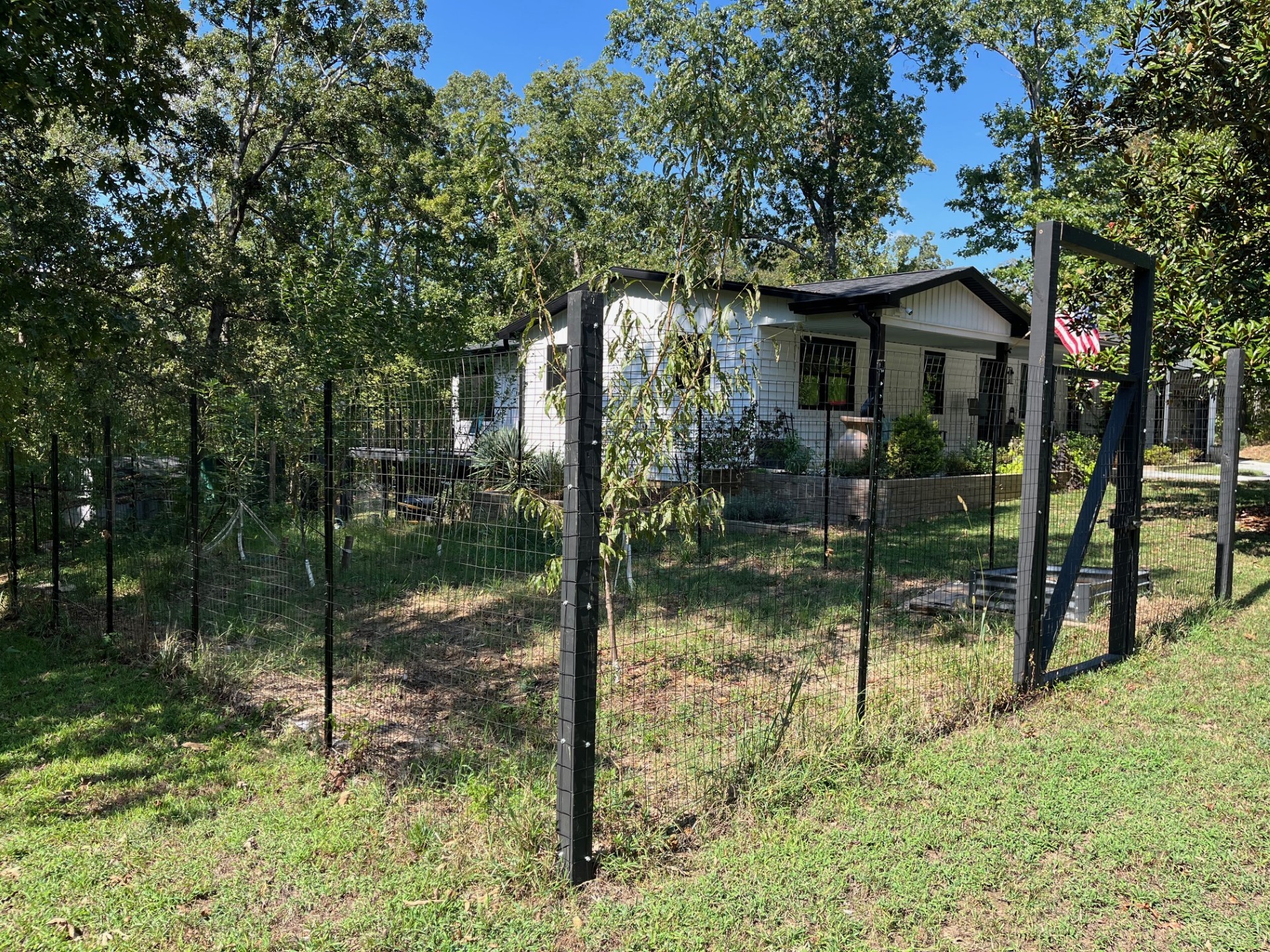 2785 Cypress Road Buchanan, TN 38222 - Photo 26 of 52 a backyard of a house with plants and large trees