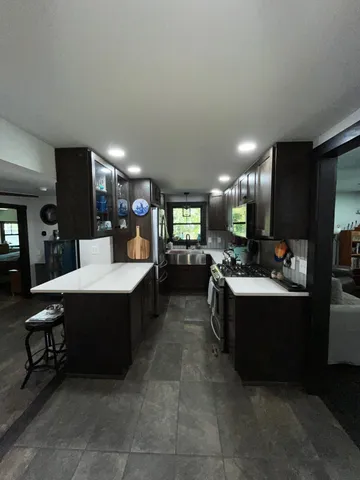 a spacious bedroom with a bed and a mirror on the dresser