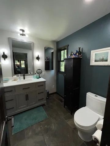 a bedroom with furniture and a flat screen tv