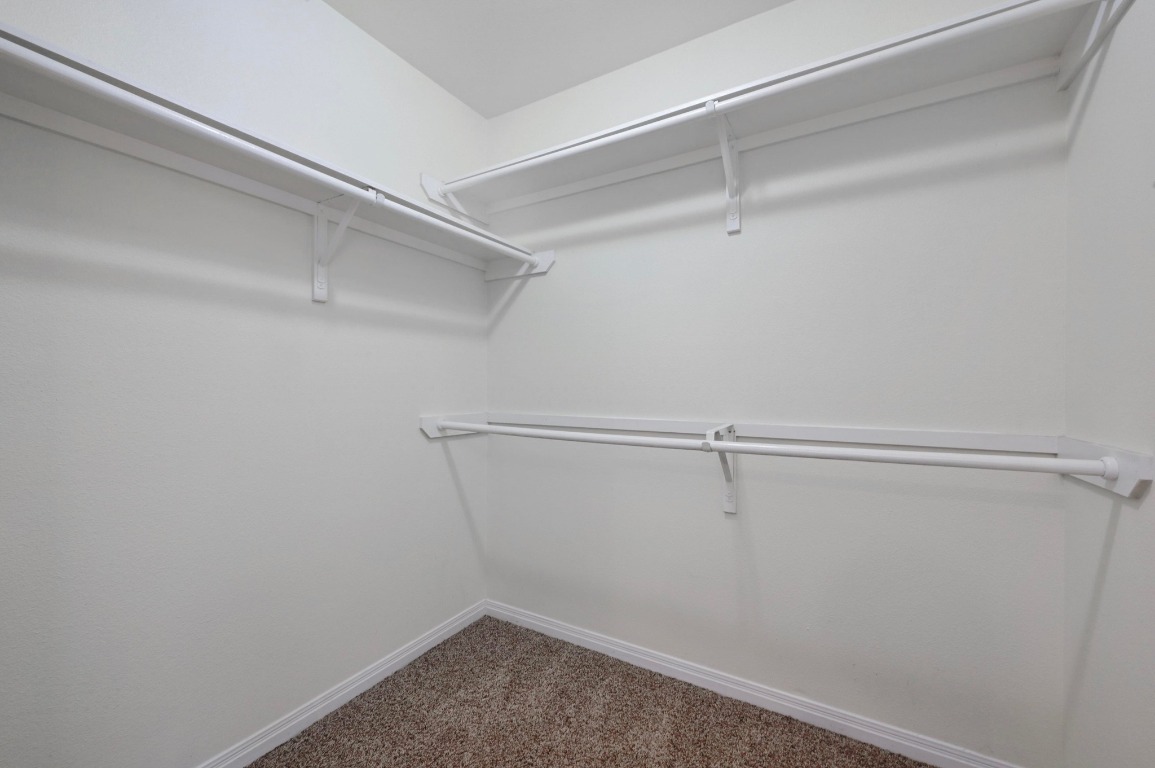 4204 Bob Wire Road Spicewood, TX 78669 - Photo 16 of 24 a view of a room with racks on the wall