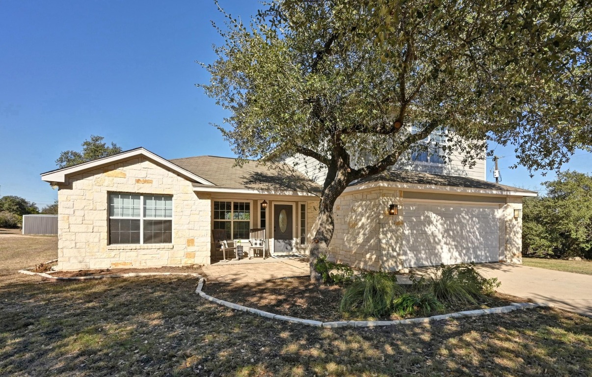 4204 Bob Wire Road Spicewood, TX 78669 - Photo 2 of 24 a front view of a house with garden