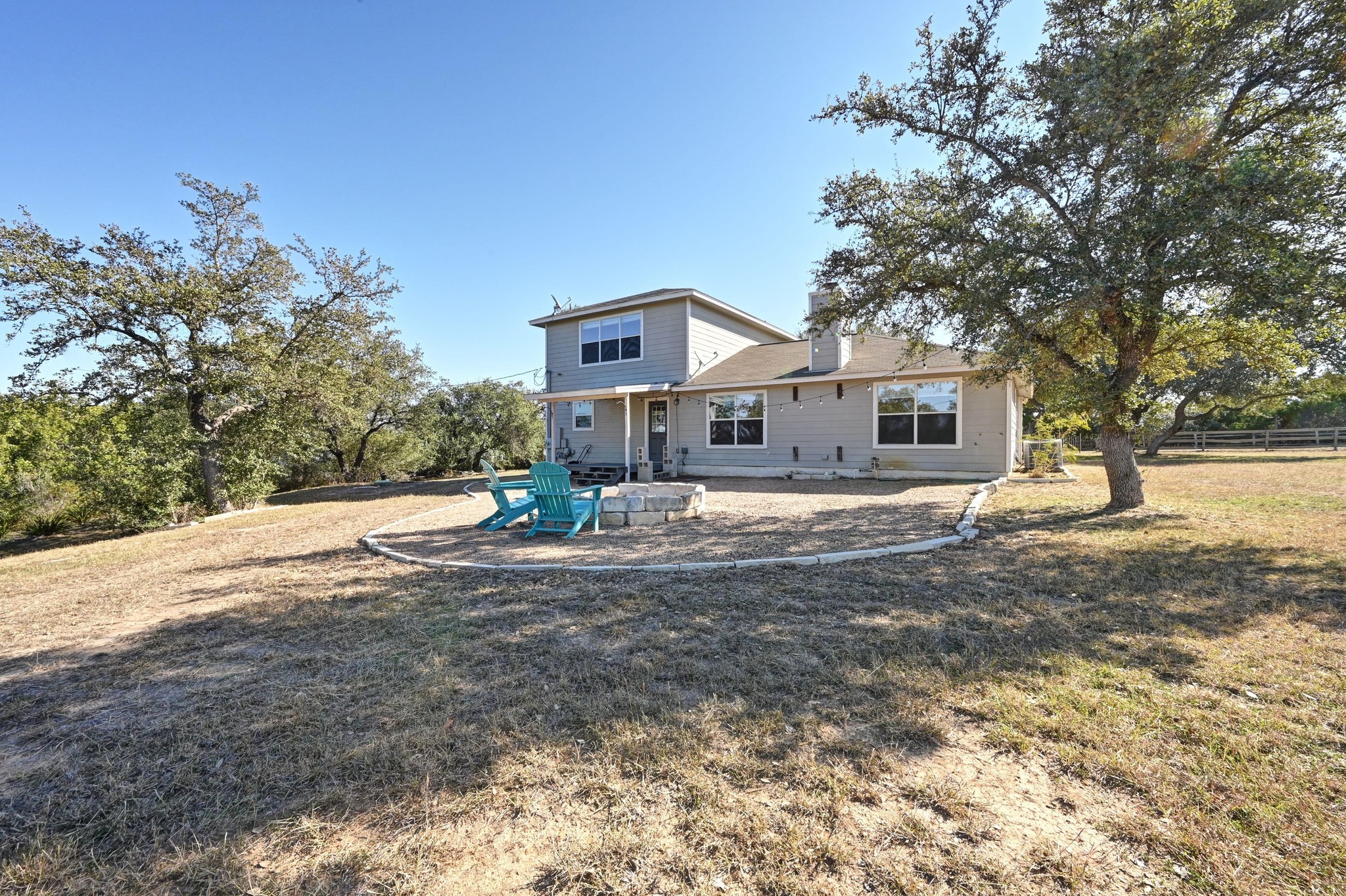 4204 Bob Wire Road Spicewood, TX 78669 - Photo 20 of 25 a front view of a house with a yard