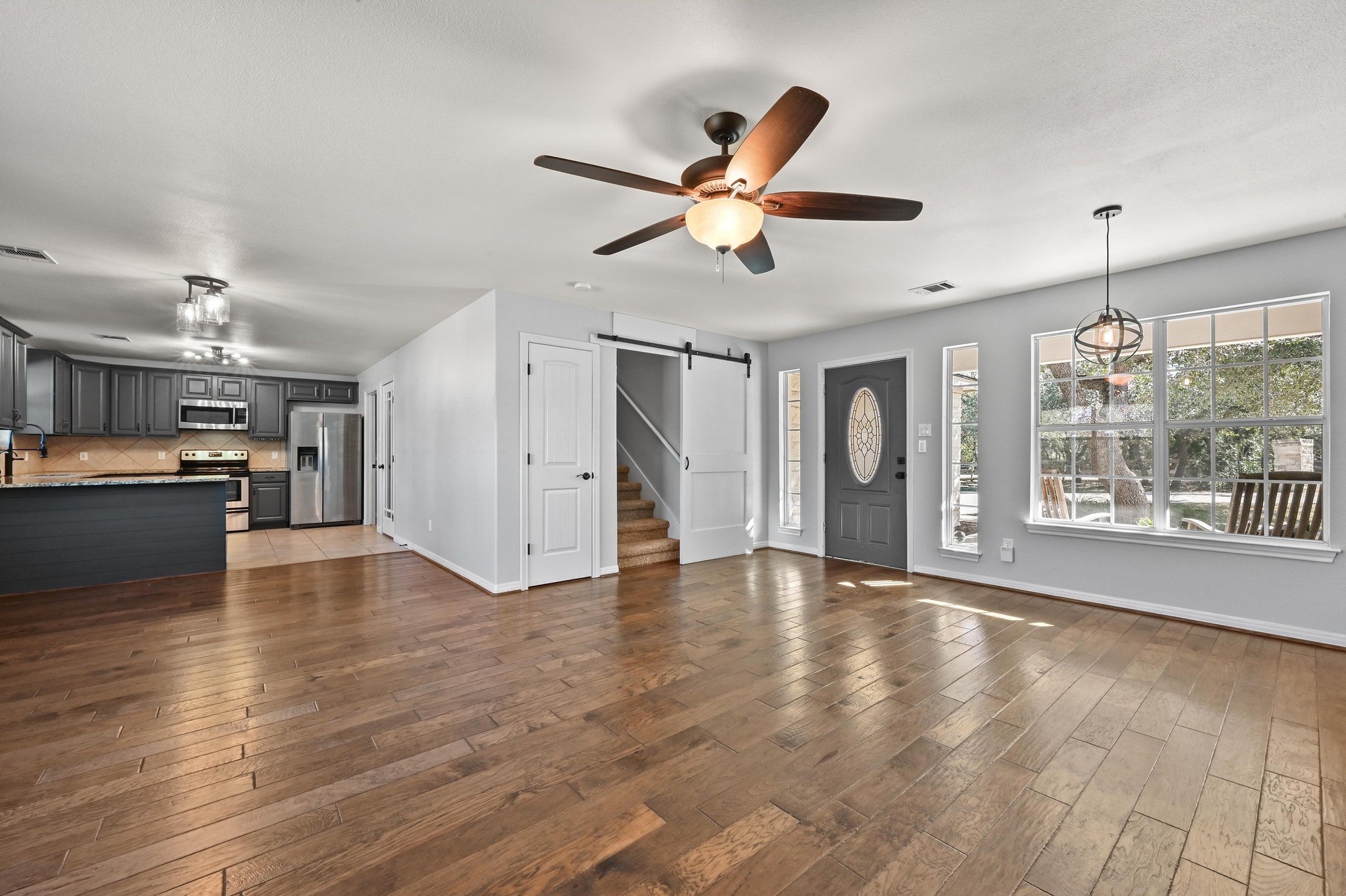 4204 Bob Wire Road Spicewood, TX 78669 - Photo 25 of 25 a view of an empty room with window and wooden floor