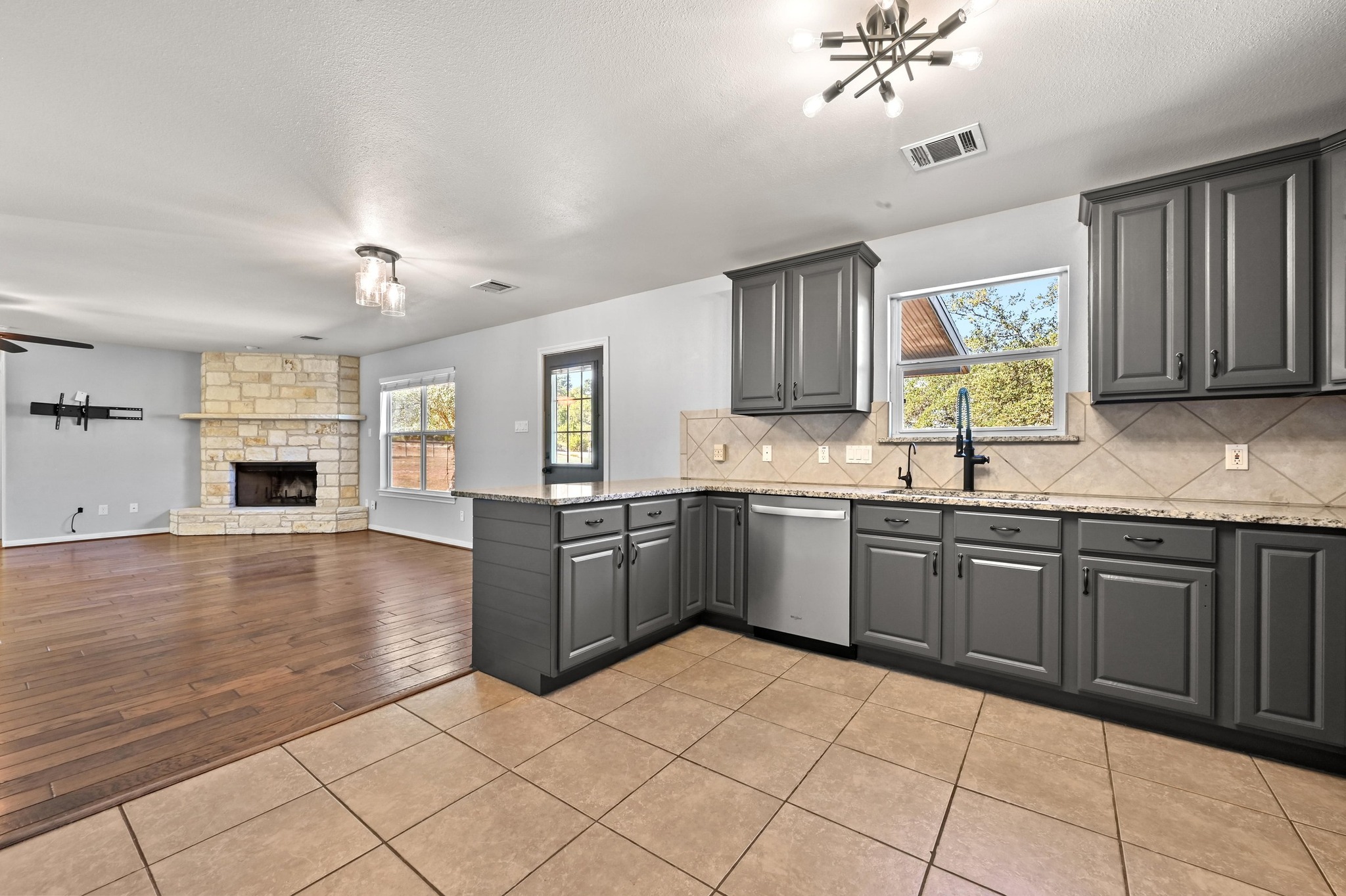 4204 Bob Wire Road Spicewood, TX 78669 - Photo 7 of 25 a kitchen with stainless steel appliances granite countertop a refrigerator sink and cabinets