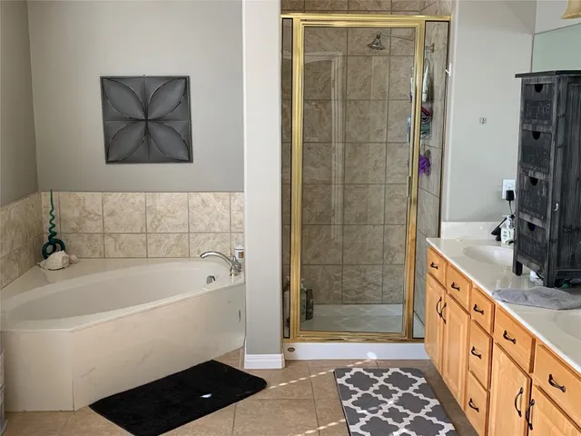 a bathroom with a bathtub and a shower
