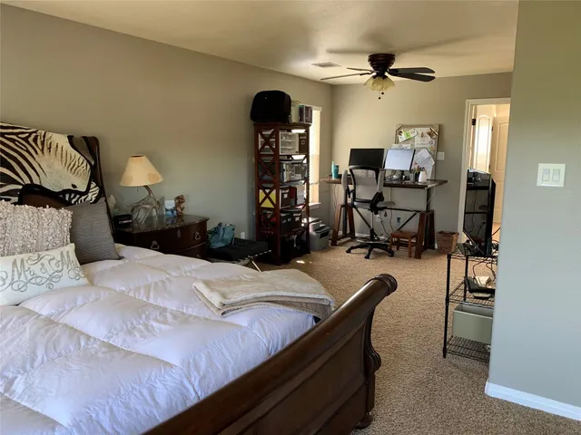 a bed room with a bed and a chair