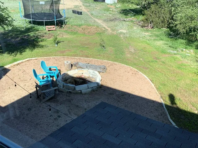 a view of a swimming pool with a yard