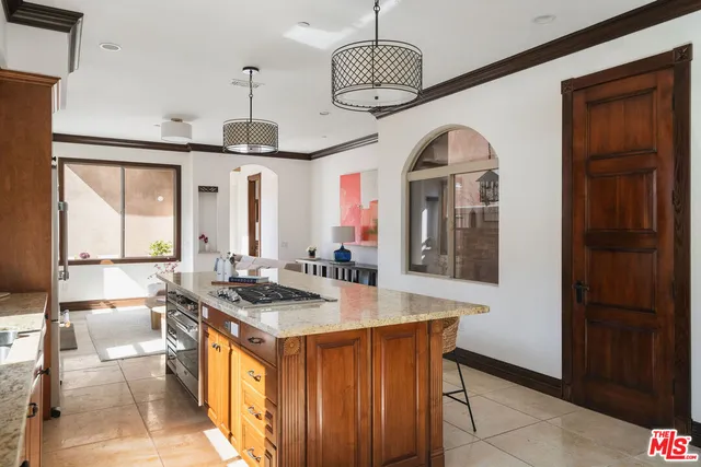 a kitchen with stainless steel appliances granite countertop a stove and a refrigerator