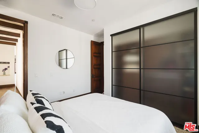a bedroom with furniture and wooden floor