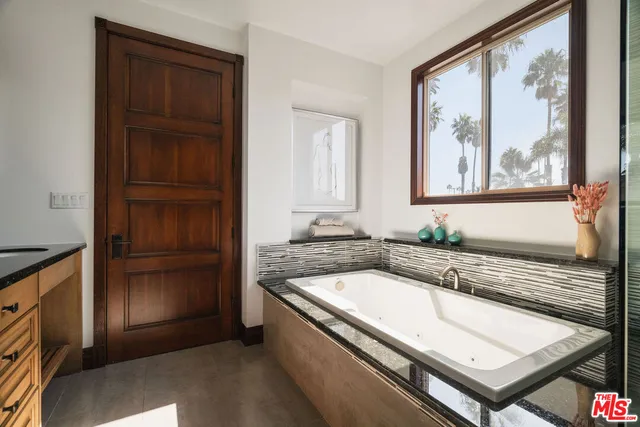 a living room with furniture fireplace and a large window