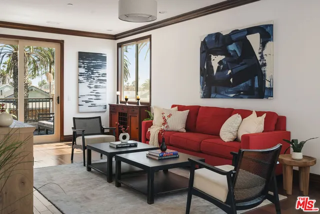 a view of a balcony with furniture and floor to ceiling window