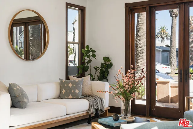 a living room with furniture and a floor to ceiling window