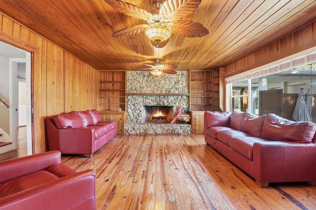 5415 Riverside Drive Yankeetown, FL 34498 - Photo 12 of 45 a living room with furniture a fireplace and a chandelier