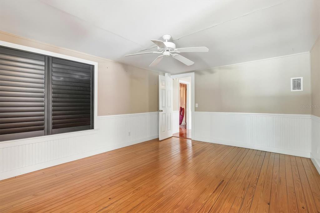 5415 Riverside Drive Yankeetown, FL 34498 - Photo 15 of 45 a view of an empty room with wooden floor and a ceiling fan