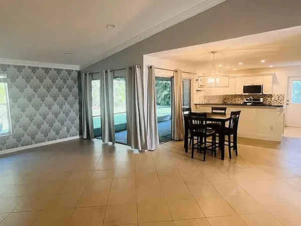 a kitchen with a table and chairs in it