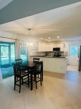 a kitchen with stainless steel appliances granite countertop a sink and a stove
