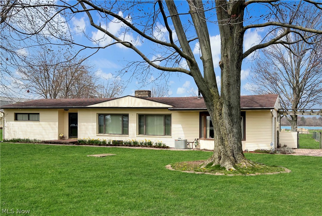 4663 East Harbor Road Port Clinton, OH 43452 - Photo 1 of 31 Ranch-style house with central AC and a front lawn