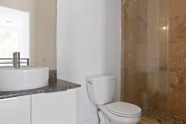 a view of hallway with wooden floor and a window