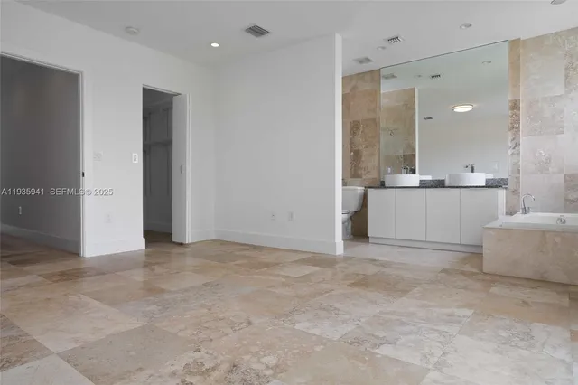 a bathroom with a sink a mirror and a bathtub