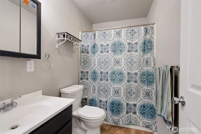a bathroom with a sink toilet and shower