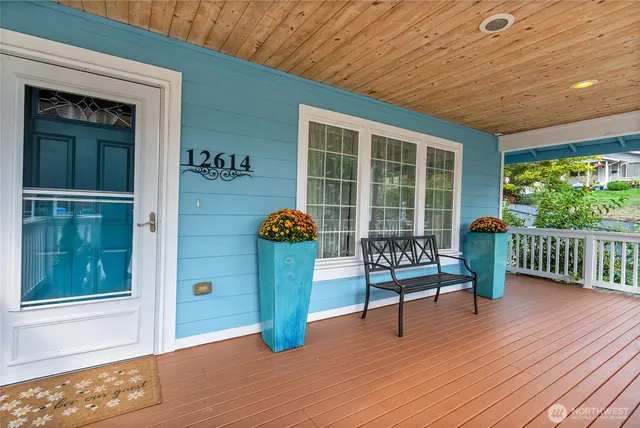 a view of a deck with wooden floor and outdoor seating