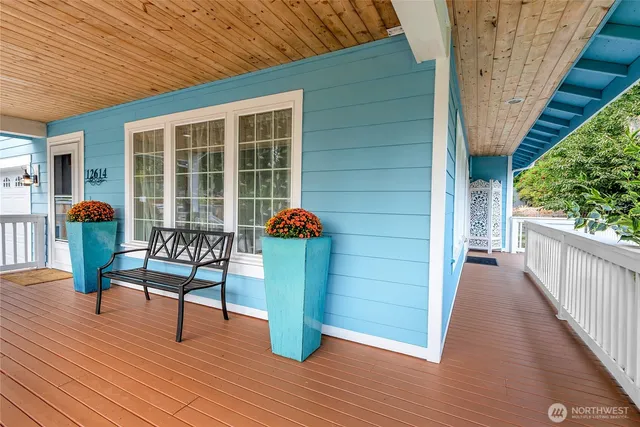 a view of a porch with furniture and wooden floor